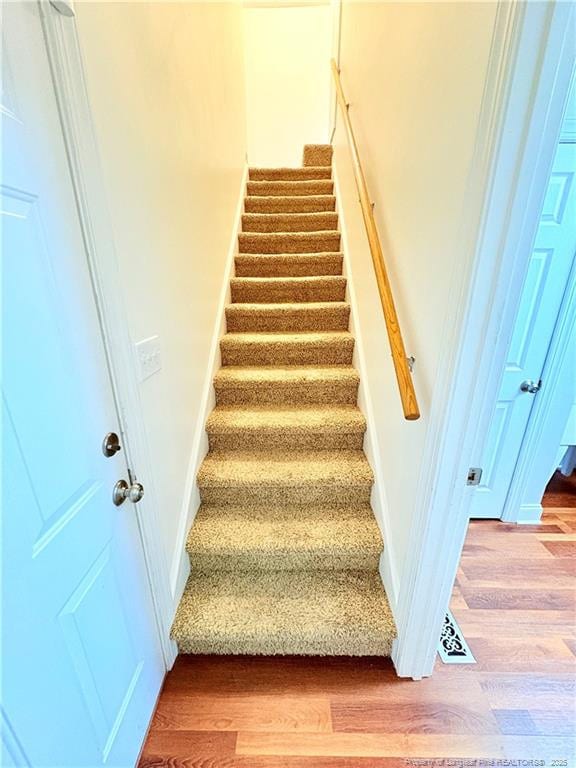 stairs with wood finished floors