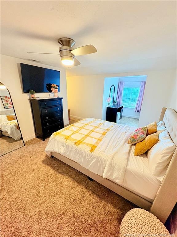 carpeted bedroom featuring ceiling fan and baseboards