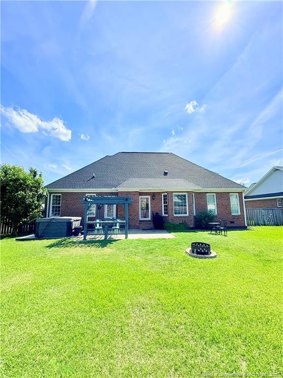 back of property featuring a pergola, a patio area, a fire pit, and brick siding