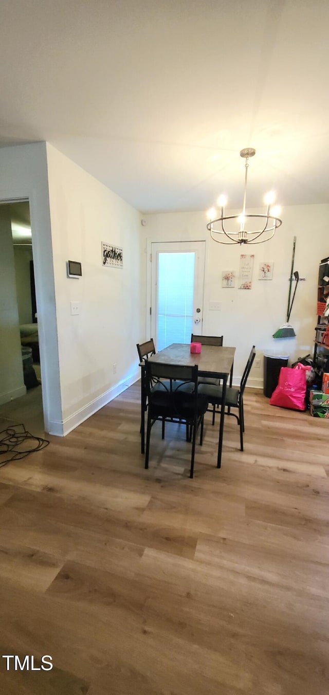 212 Placid Pond Dr, Broadway, NC 27505 - dining space featuring wood finished floors, a chandelier, and baseboards