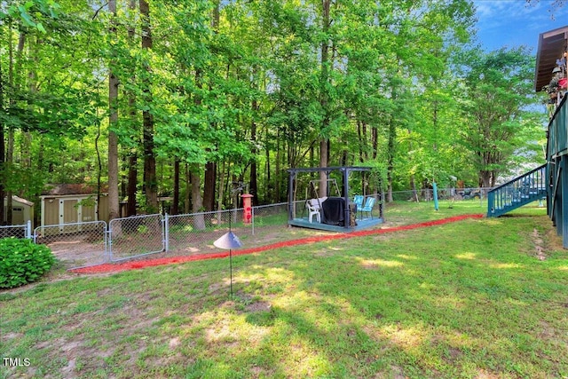 view of yard with a gate, stairway, and a storage shed