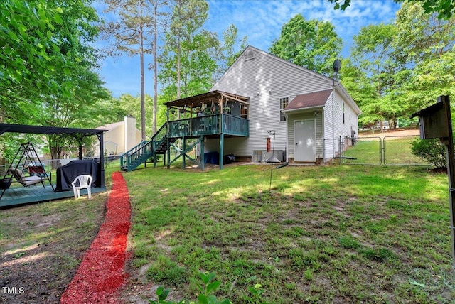 rear view of property with a gate, stairway, and a wooden deck