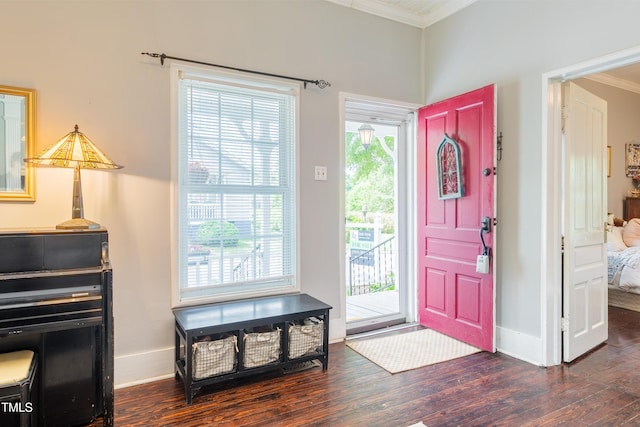 foyer featuring crown molding, wood finished floors, and baseboards