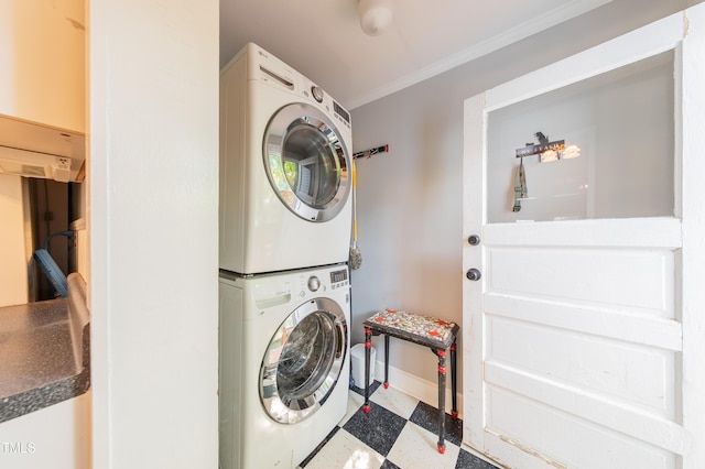 washroom with stacked washer / drying machine, tile patterned floors, ornamental molding, and baseboards