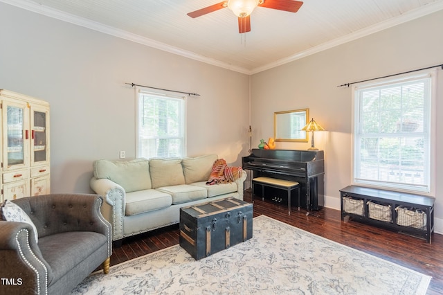 living room featuring ceiling fan, wood finished floors, ornamental molding, and baseboards