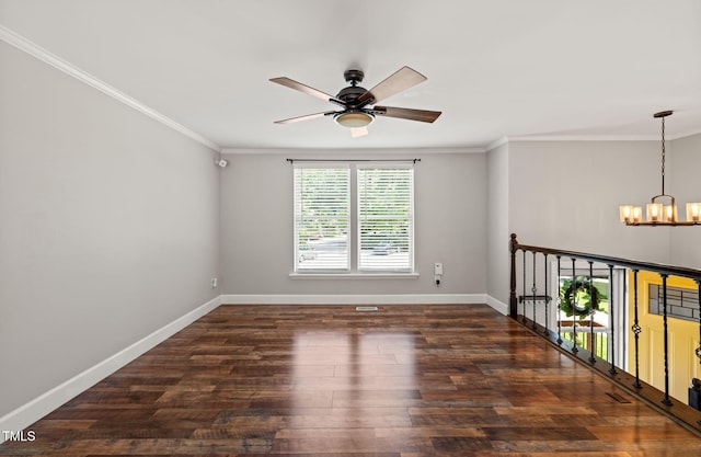 unfurnished room featuring ceiling fan, a chandelier, baseboards, ornamental molding, and wood finished floors