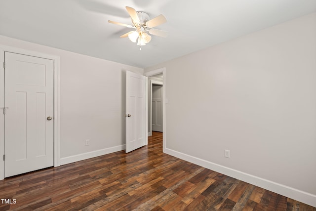 unfurnished bedroom featuring baseboards, dark wood-style flooring, and ceiling fan