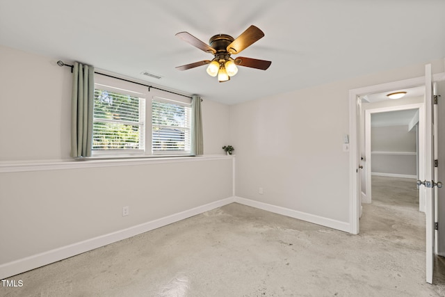 spare room with baseboards, a ceiling fan, and unfinished concrete floors