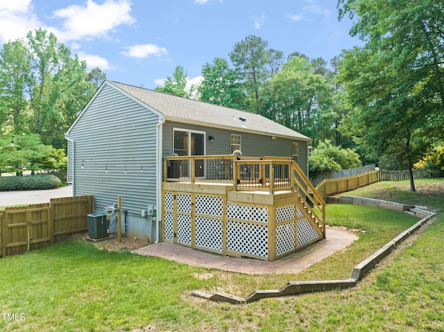 rear view of property with a deck, central air condition unit, and a shingled roof