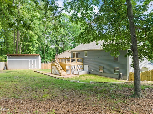 back of house with a wooden deck, stairway, an outbuilding, and a storage unit