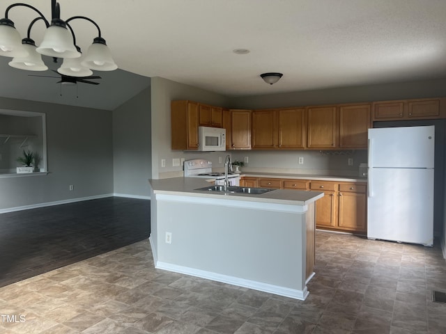kitchen with white appliances, baseboards, brown cabinets, light countertops, and pendant lighting