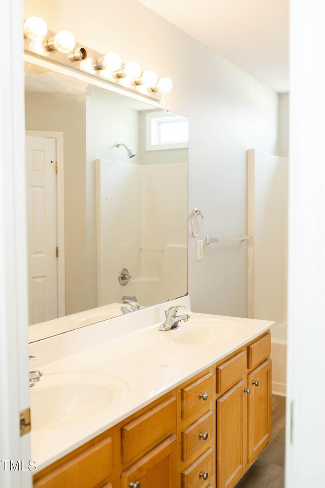 12 Linsey Ct, Lillington, NC 27546 - full bathroom featuring double vanity, shower / bathtub combination, and wood finished floors
