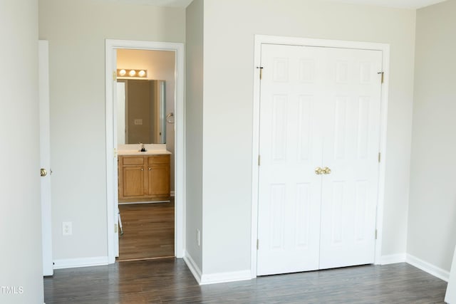 12 Linsey Ct, Lillington, NC 27546 - unfurnished bedroom with dark wood finished floors, baseboards, and a closet