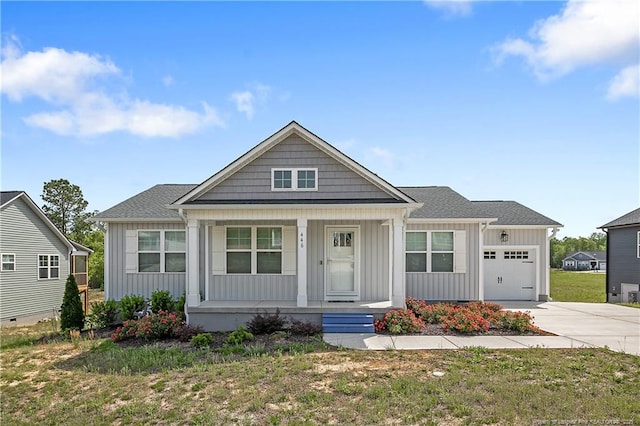 446 Placid Pond Dr, Broadway, NC 27505 - view of front of home featuring board and batten siding, covered porch, a garage, driveway, and a front lawn