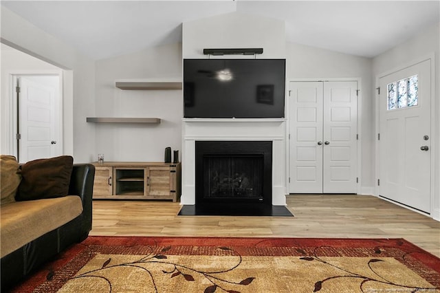 446 Placid Pond Dr, Broadway, NC 27505 - living room with lofted ceiling, wood finished floors, and a fireplace with flush hearth