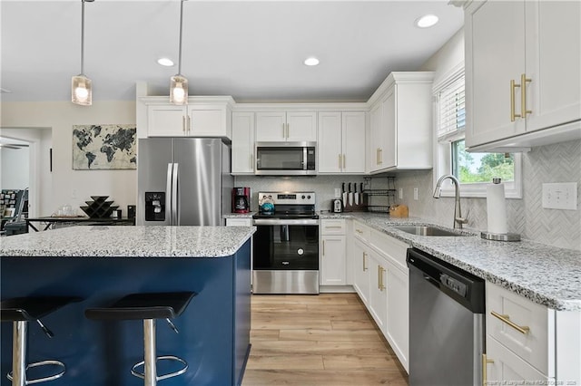 446 Placid Pond Dr, Broadway, NC 27505 - kitchen with appliances with stainless steel finishes, a sink, a breakfast bar, white cabinets, and recessed lighting