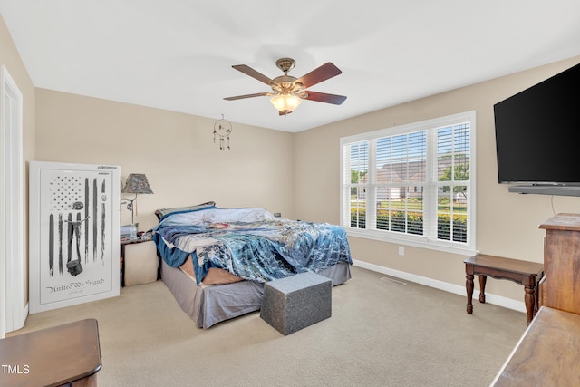 carpeted bedroom featuring baseboards and ceiling fan