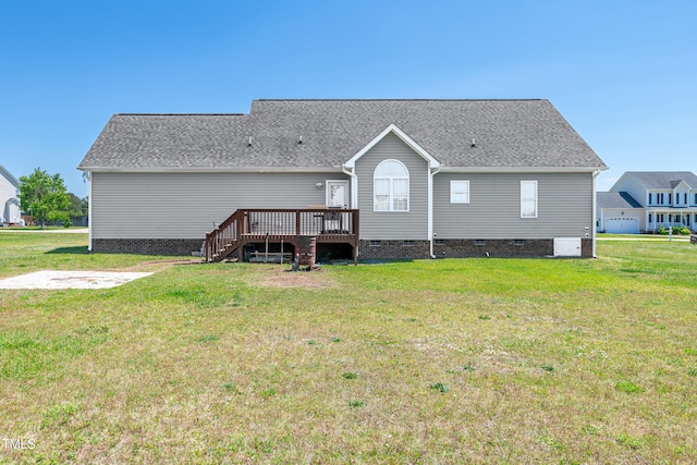 back of property with crawl space, a deck, a yard, a shingled roof, and stairs