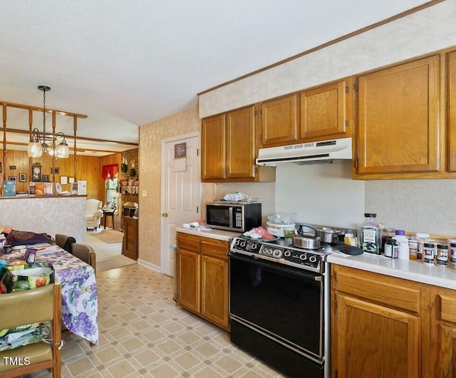 kitchen with under cabinet range hood, electric range, stainless steel microwave, light countertops, and a textured ceiling