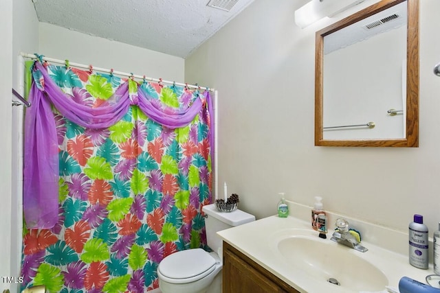 bathroom featuring toilet, vanity, a shower with curtain, and a textured ceiling