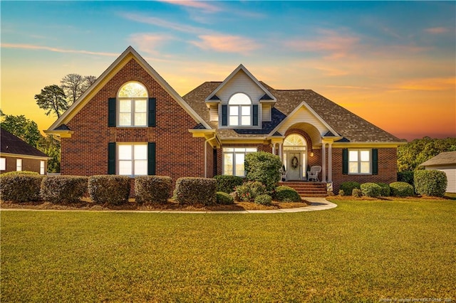 1110 Oakridge Blvd, Lumberton, NC 28358 - traditional-style home featuring brick siding, a lawn, and a shingled roof