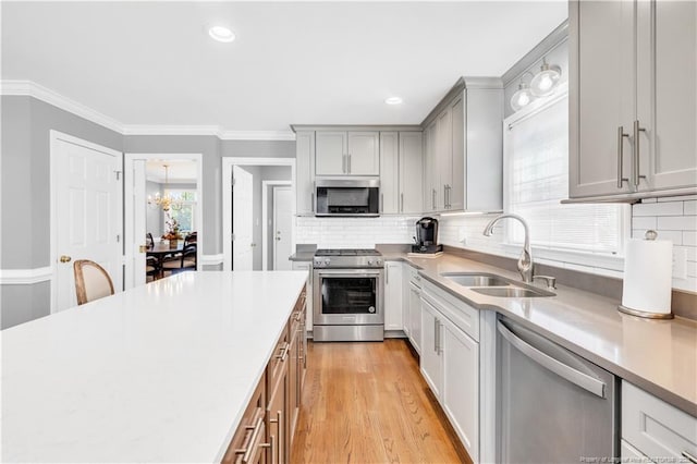 1110 Oakridge Blvd, Lumberton, NC 28358 - kitchen featuring appliances with stainless steel finishes, a sink, light countertops, gray cabinetry, and decorative backsplash