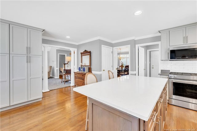 1110 Oakridge Blvd, Lumberton, NC 28358 - kitchen featuring appliances with stainless steel finishes, ornate columns, recessed lighting, a kitchen island, and gray cabinetry