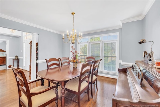1110 Oakridge Blvd, Lumberton, NC 28358 - dining room with light wood-type flooring, ornamental molding, a chandelier, and ornate columns
