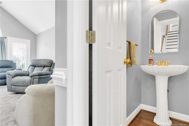1110 Oakridge Blvd, Lumberton, NC 28358 - bathroom featuring lofted ceiling, baseboards, and wood finished floors