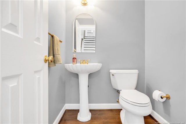 1110 Oakridge Blvd, Lumberton, NC 28358 - bathroom with toilet, wood finished floors, and baseboards