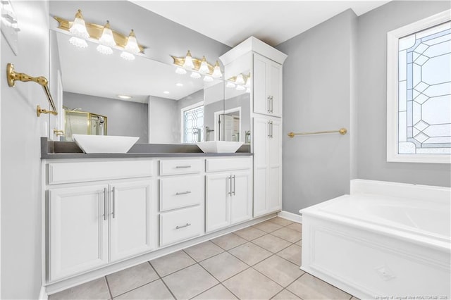 1110 Oakridge Blvd, Lumberton, NC 28358 - bathroom featuring double vanity, tile patterned floors, a garden tub, and baseboards