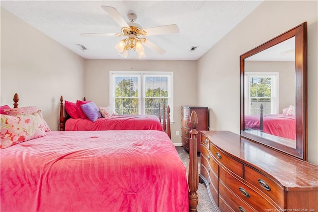 1110 Oakridge Blvd, Lumberton, NC 28358 - bedroom with dark colored carpet, baseboards, and ceiling fan