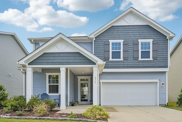 view of front facade with covered porch, driveway, and an attached garage