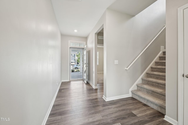 entryway with dark wood finished floors, stairway, baseboards, and recessed lighting