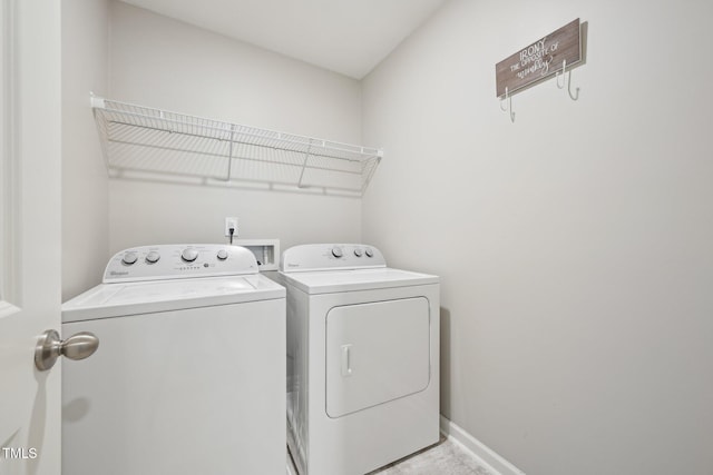 washroom with independent washer and dryer and baseboards