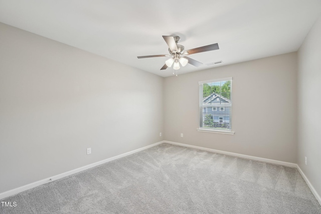 spare room featuring baseboards, carpet, and ceiling fan