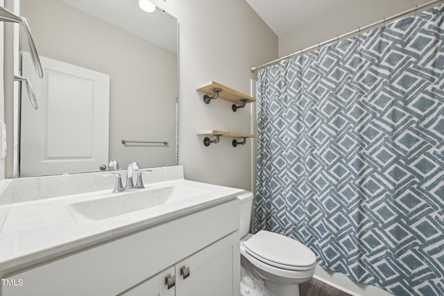 full bathroom featuring toilet, vanity, and a shower with curtain