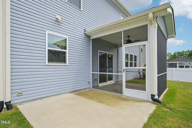 view of patio with a ceiling fan and a sunroom