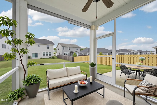 sunroom featuring a residential view, a ceiling fan, outdoor lounge area, and outdoor dining area