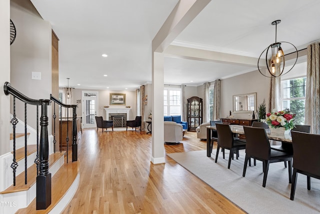 dining area with stairs, light wood-style flooring, crown molding, recessed lighting, and a chandelier