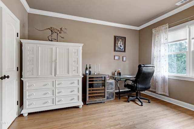 office area featuring light wood-type flooring, crown molding, baseboards, and beverage cooler