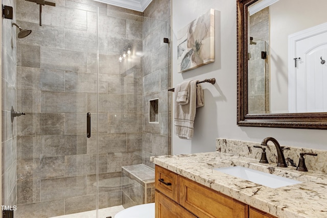 bathroom featuring a shower stall, ornamental molding, vanity, and toilet