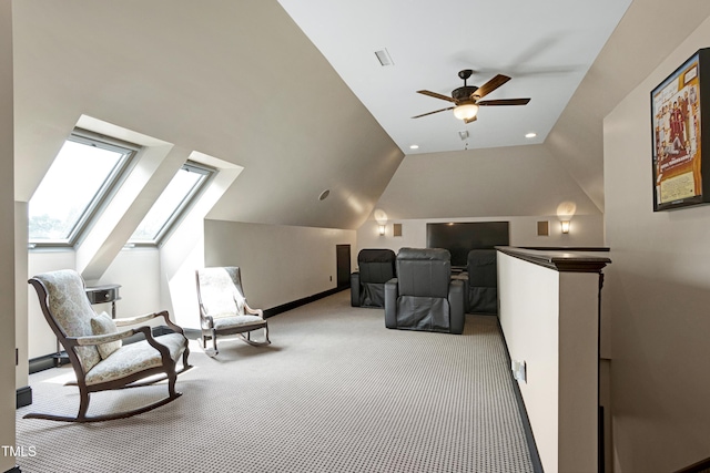 living area with carpet flooring, lofted ceiling, a ceiling fan, a skylight, and baseboards