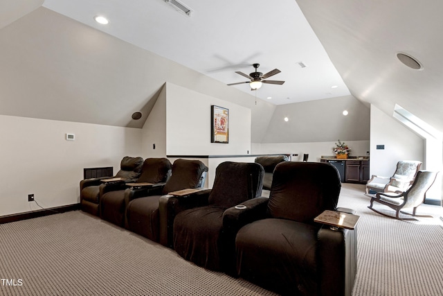 home theater room with light colored carpet, lofted ceiling, ceiling fan, recessed lighting, and baseboards