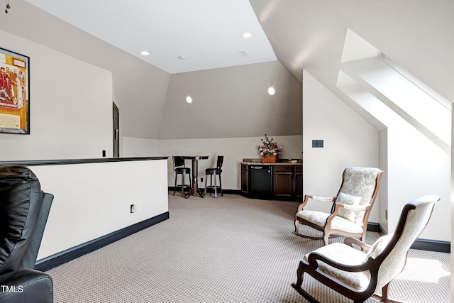 living area featuring light colored carpet, lofted ceiling, a skylight, recessed lighting, and baseboards