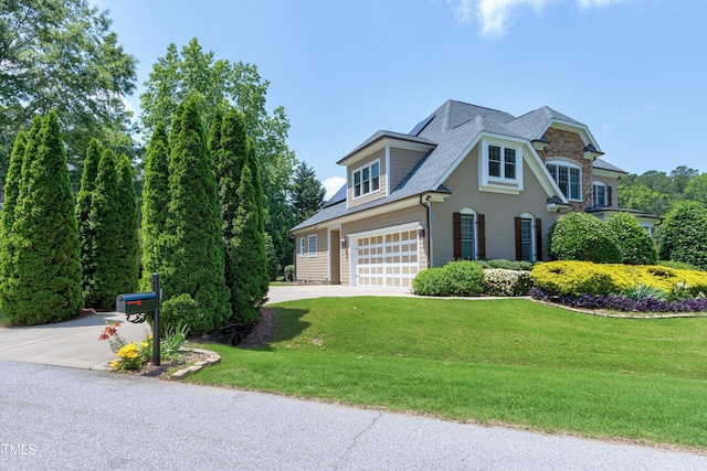 view of front facade featuring concrete driveway, a garage, a front lawn, roof with shingles, and brick siding