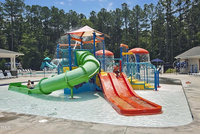 community play area featuring a water play area and fence
