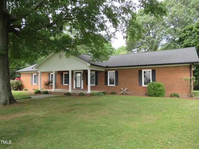 819 Patterson Grove Rd, Ramseur, NC 27316 - ranch-style home with brick siding, covered porch, a front yard, and a shingled roof