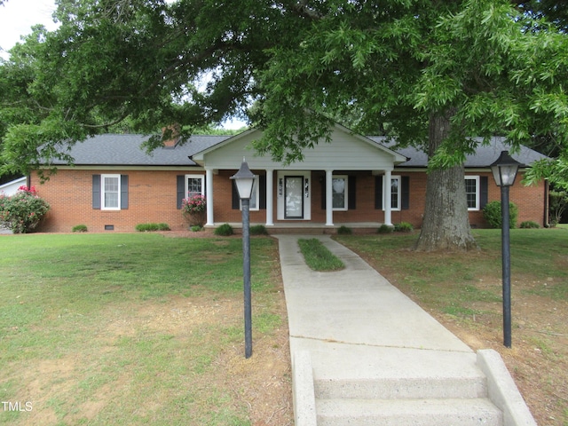 819 Patterson Grove Rd, Ramseur, NC 27316 - ranch-style home featuring brick siding, a porch, a front lawn, concrete driveway, and a shingled roof