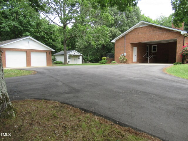 819 Patterson Grove Rd, Ramseur, NC 27316 - view of side of property with brick siding, an outbuilding, and a detached garage
